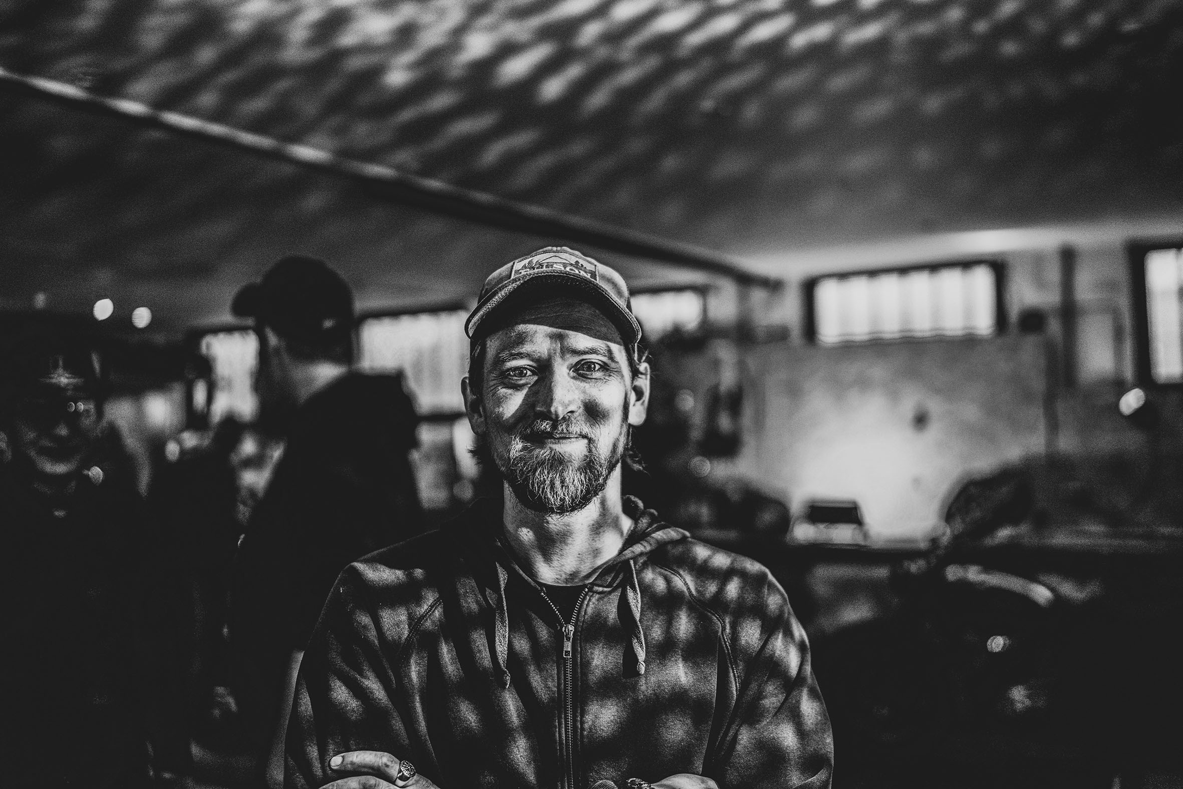 biker with a beard and smiling, party background